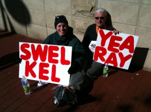 Me & my dad with our signs (thanks Mom!) after the marathon